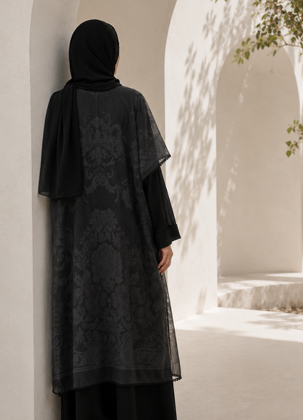 Back view of Narin 12 black dress set showing the drape and tonal woven floral artwork of the overlay.
